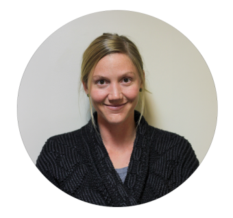 Smiling woman with blonde hair wearing a dark blazer, circular cropped portrait photo.