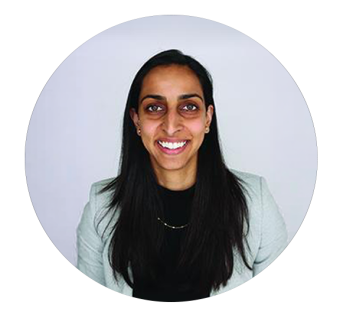 Smiling woman with long dark hair wearing a light green blazer, circular crop portrait.