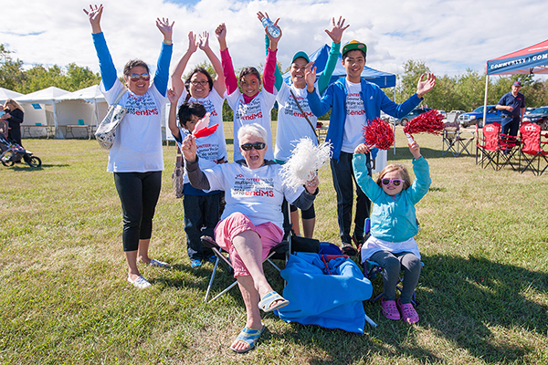 A group of volunteers celebrates and smiles.