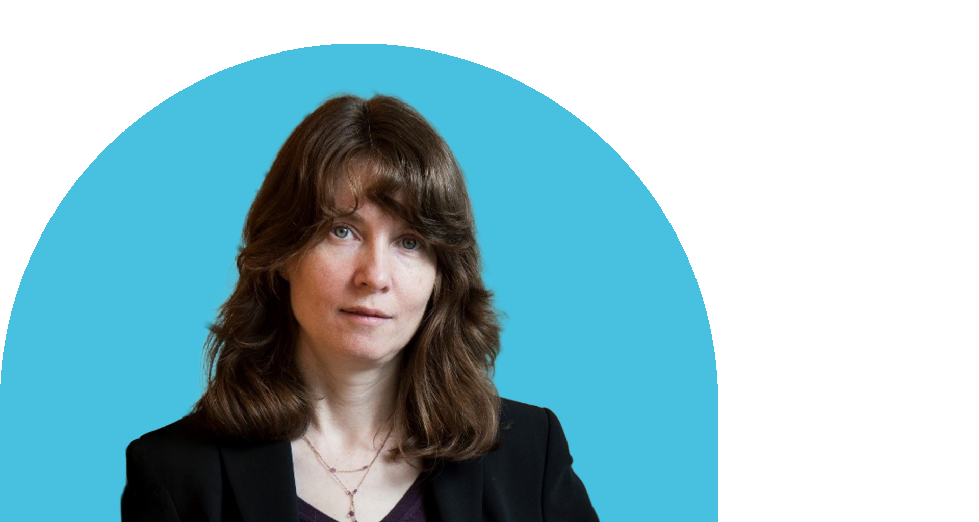 A woman with medium length brown hair is wearing a black top and jacket. 