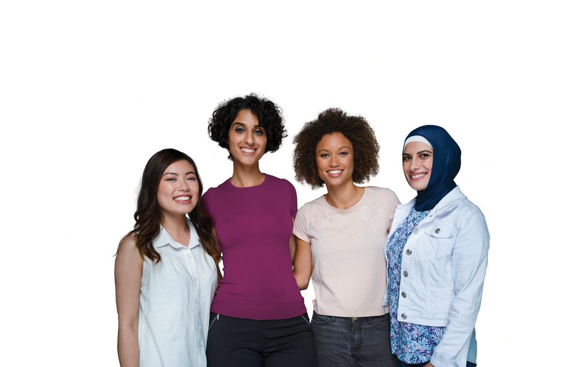 Four women stand together with their arms behind eachother.
