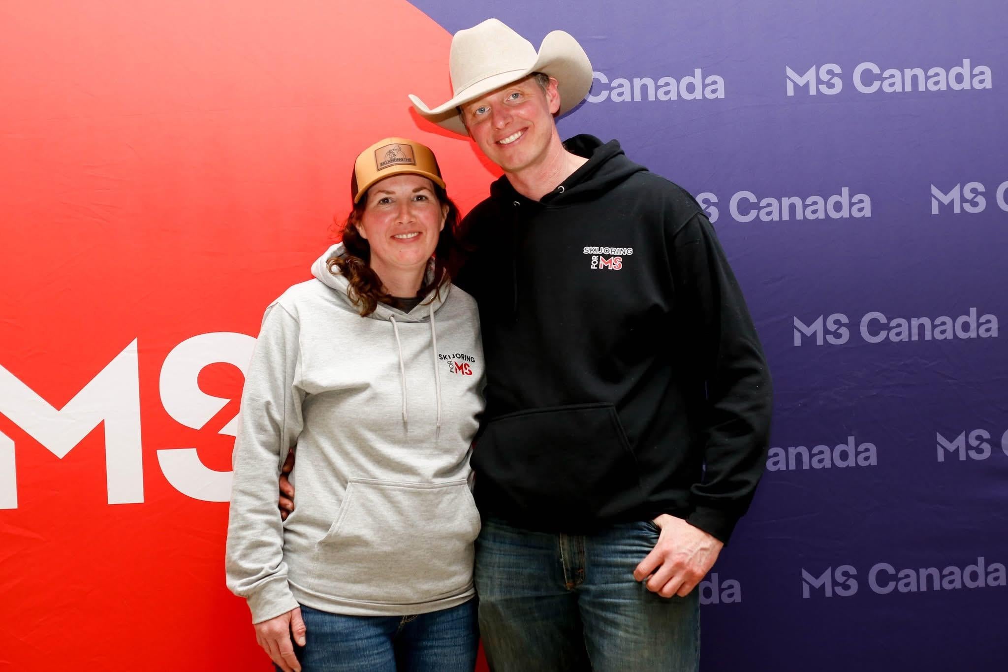 James, wearing a cowboy hat, with his wife wearing a baseball cap.