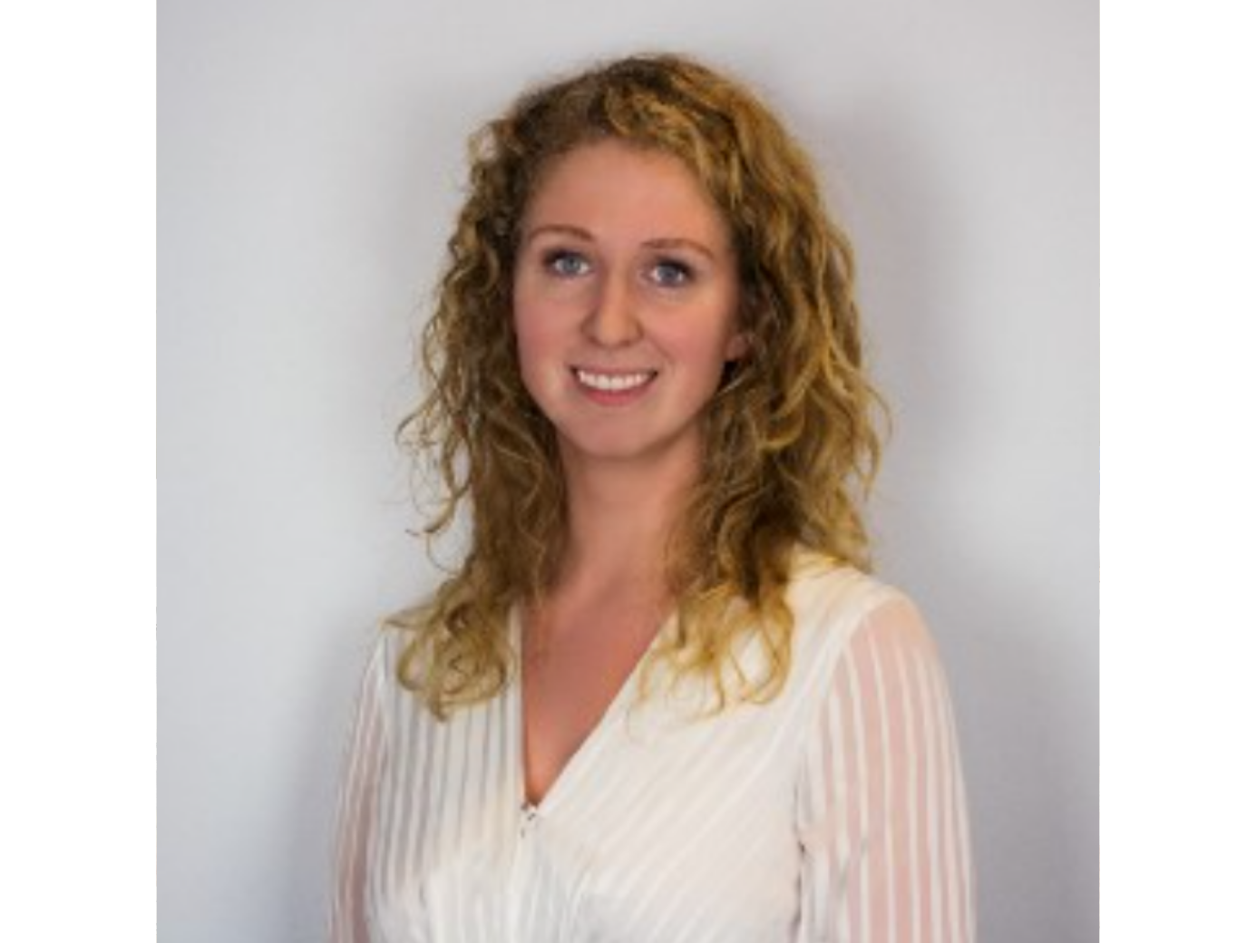 Kelsi Smith wearing a white blouse, professional headshot.
