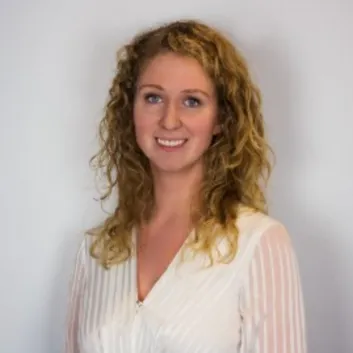 Kelsi Smith wearing a white blouse, professional headshot.